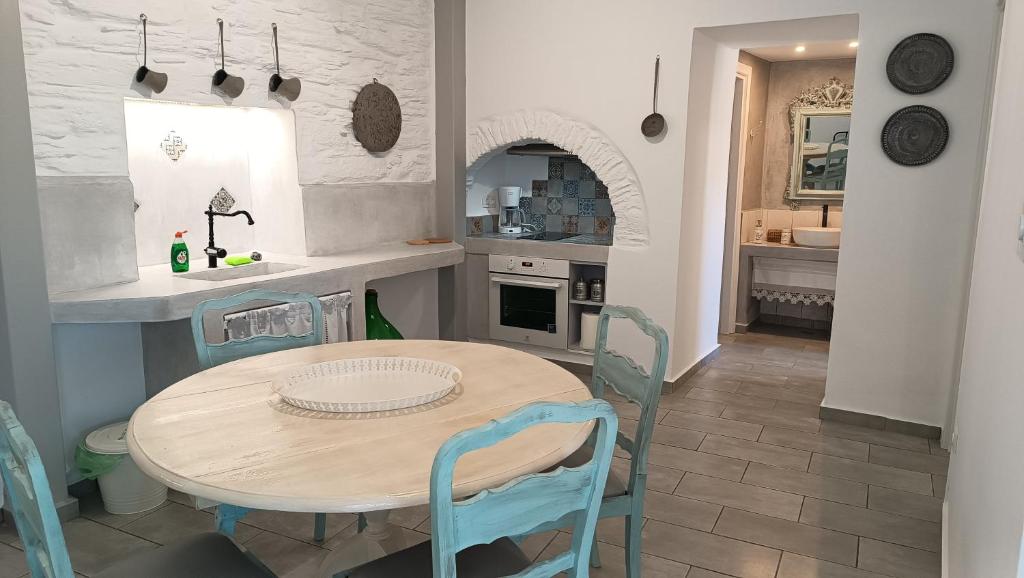 a kitchen and dining room with a table and chairs at Est 1852 Andros - Tower 1 in Lámira
