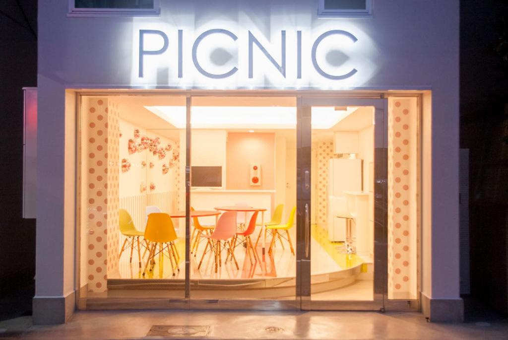 a store front with a table and chairs at Picnic Hostel Osaka in Osaka