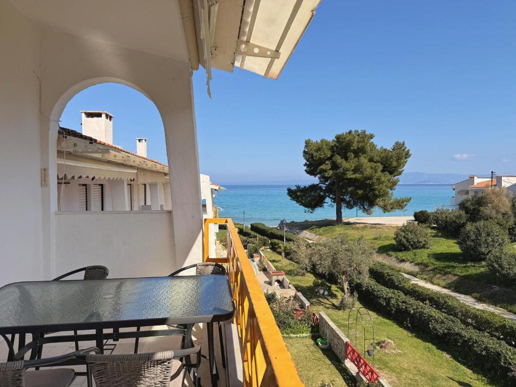 a balcony with a view of the ocean at Hanioti Beach Front Apartments in Hanioti