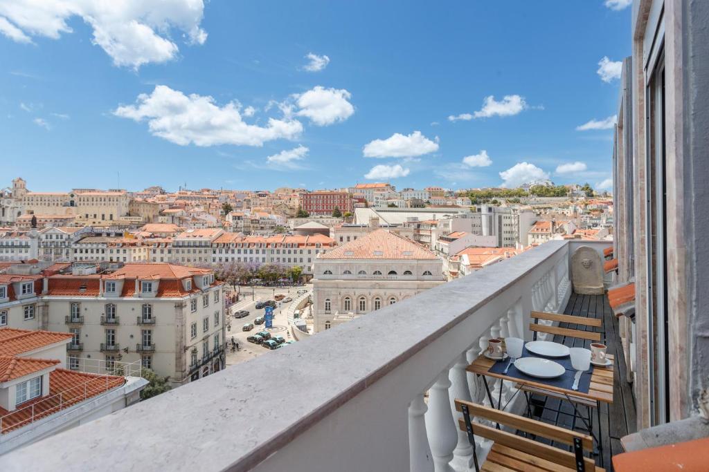 a balcony with a view of a city at Rossio individual Suites Lisbon in Lisbon