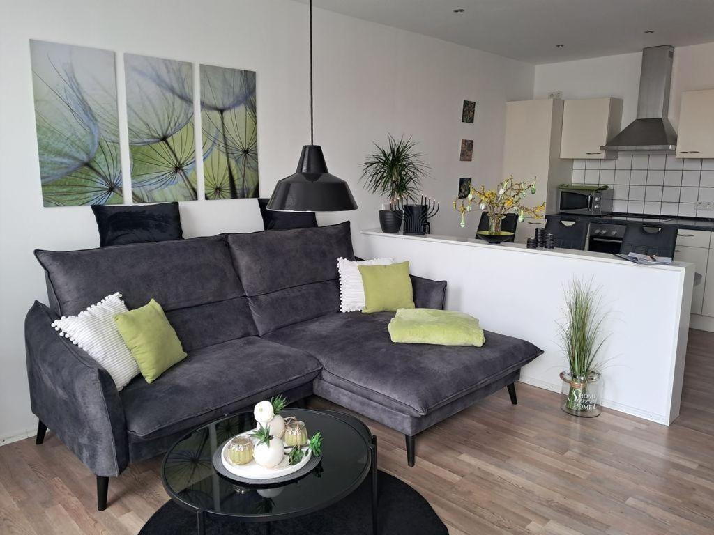 a living room with a couch and a table at Op-England-I-mit-Terrasse-grossem-Garten in Nordstrand