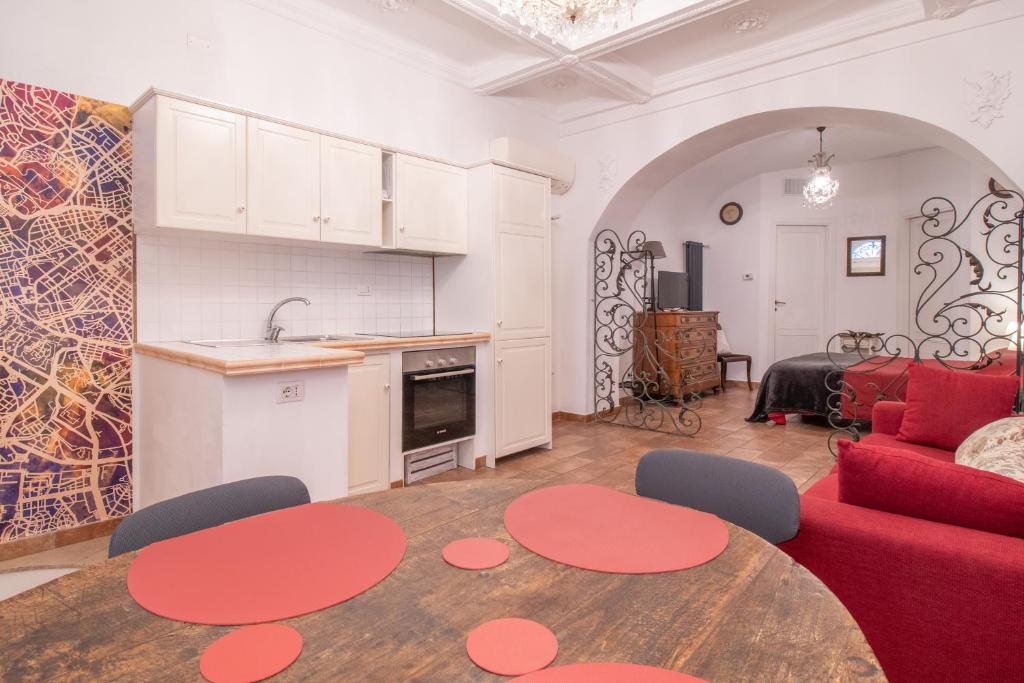 a living room with a red couch and a table at Boschetto 58 in Rome