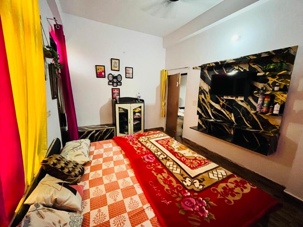 a bedroom with a bed with a red blanket at Rr Complex in Nalmatha