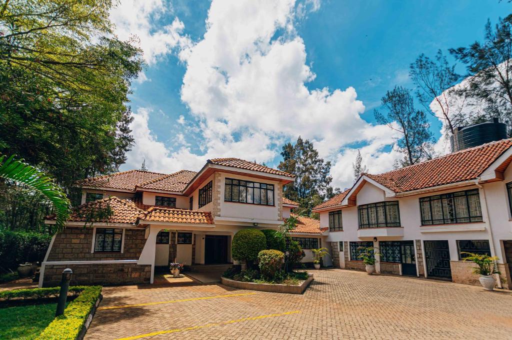 a house with a brick driveway in front of it at Karen Crown 5BR Villa in Nairobi