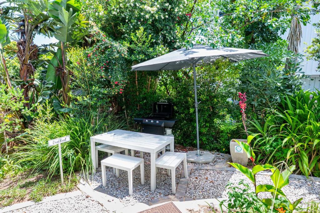 a grill with an umbrella and a table and chairs at Daai Kant - Hooggety in George