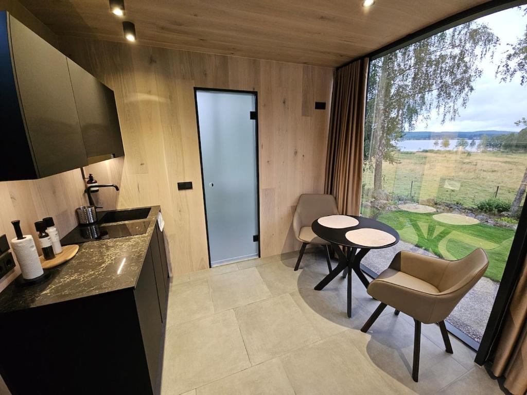 a kitchen and dining room with a table and chairs at Escape - Bollnäs in Bollnäs