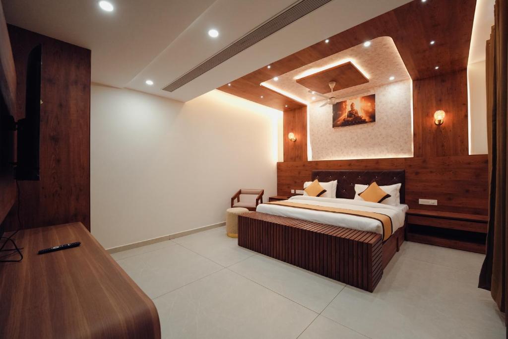 a bedroom with a bed and a wooden wall at Green View Suites in Kalyānpur
