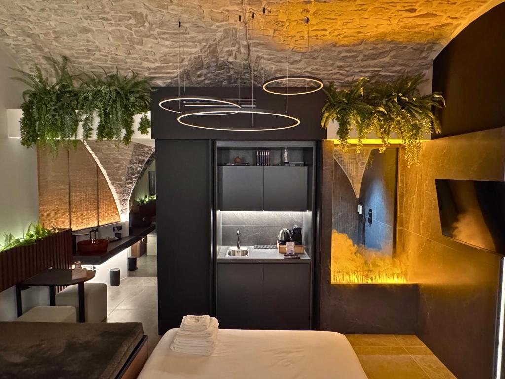 a room with a sink and a kitchen with plants at Adalina Luxury Suite in Giovinazzo