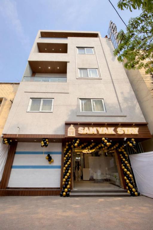 a building with a santana store in front of it at Samyak Stay in Ujjain