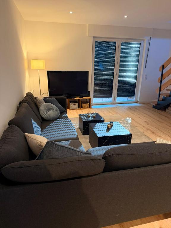 a living room with a couch and a flat screen tv at Harlehaus Nina in Friedrichsschleuse