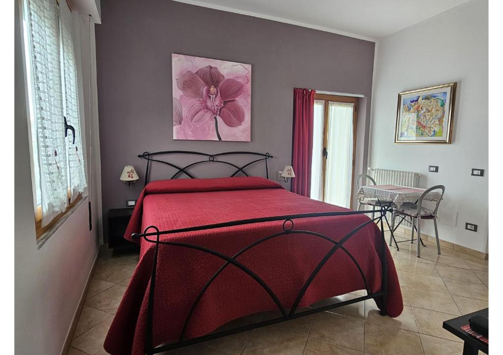 a bedroom with a bed with a red blanket at Guest house Il Giardino in Città in La Spezia