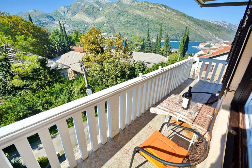 a table and chairs on a balcony with a view at Apartment Rita in Tivat