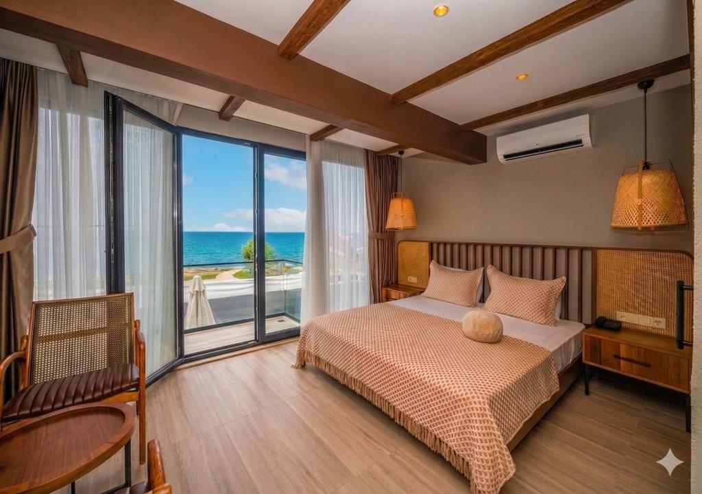 a bedroom with a bed with a view of the ocean at Villa Siesta Hotel Istanbul Airport in Karaburun