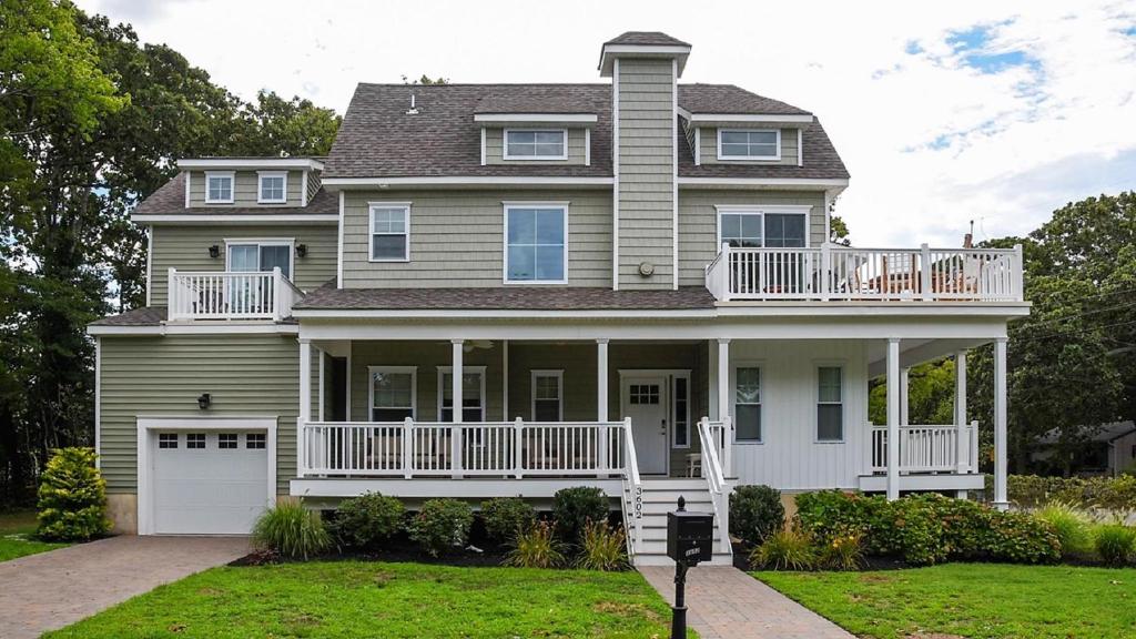 a large house with a large porch and a garage at Bay Breeze in Town Bank