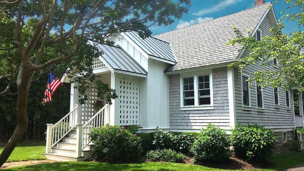 a white house with an american flag in front of it at 637 Seagrove in Cape May Point