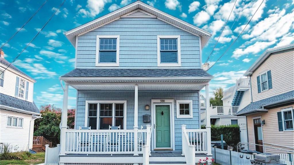 a blue house with a green door at Gray Cottage On Windsor in Cape May