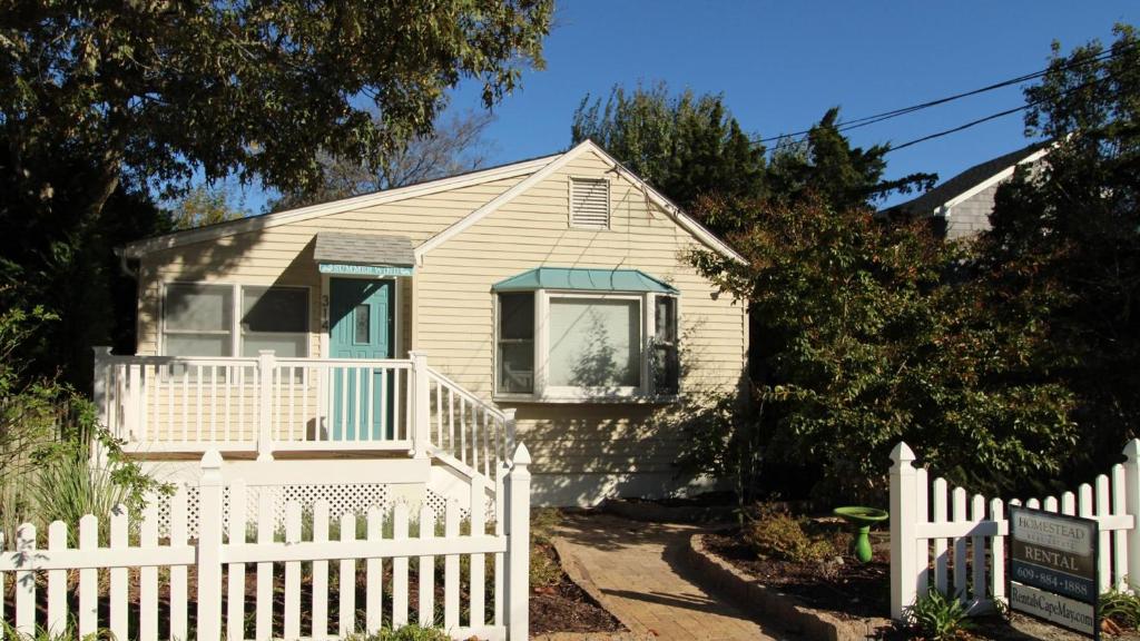 a small white house with a white picket fence at Summer Breeze in Cape May Point