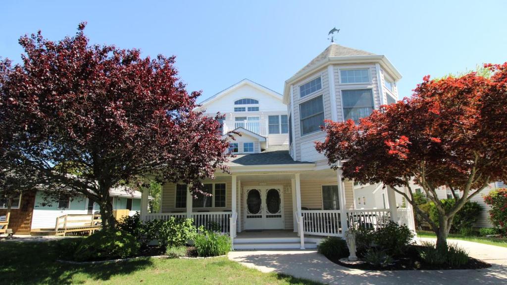 a white house with trees in front of it at Failte in West Cape May