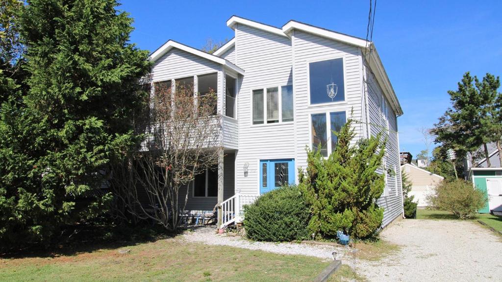 a white house with a yard at Seasons By The Sea in Cape May Point