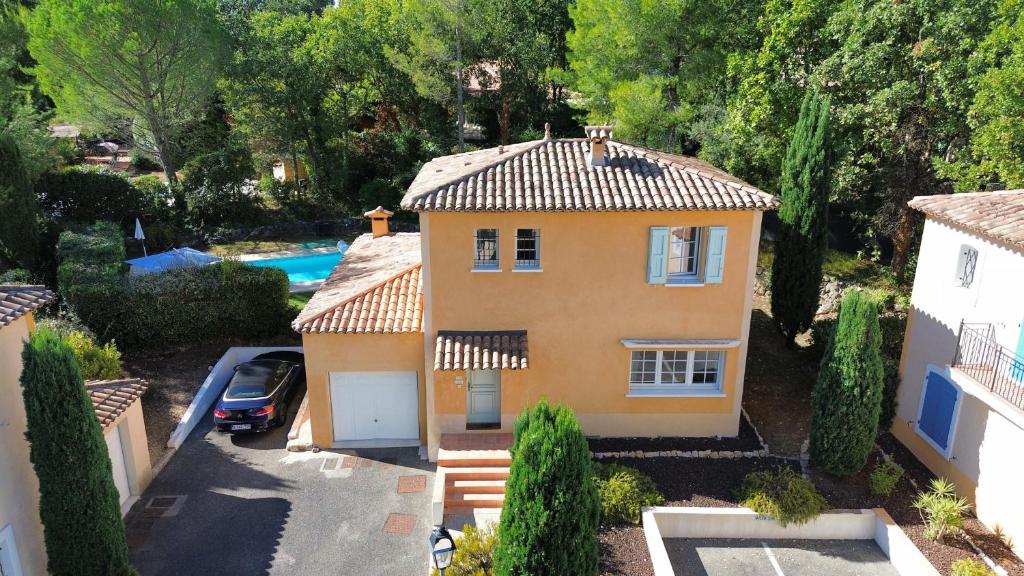 an aerial view of a yellow house with a pool at Villa Côte & Provence - private heated pool in Fayence
