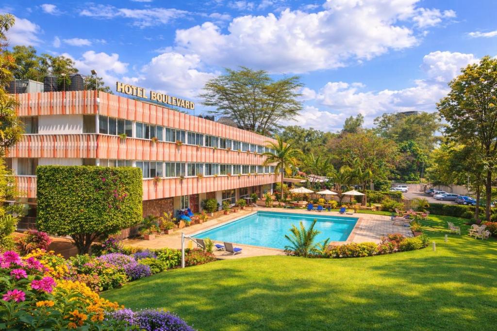 a hotel with a swimming pool and a resort at Hotel Boulevard Nairobi, City Centre CBD in Nairobi