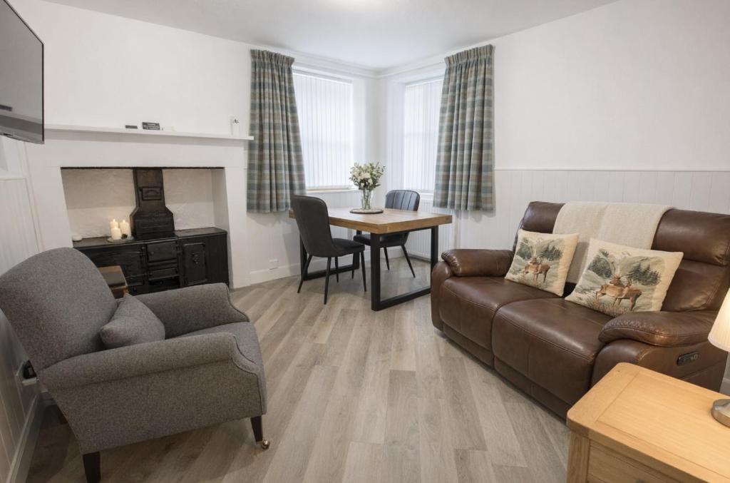 a living room with a couch and a table at Taigh Oisean 4 Birnam Place Pitlochry in Pitlochry