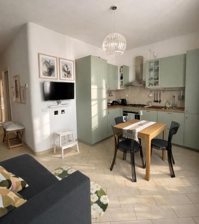 a kitchen and living room with a table and chairs at Casa aMare in Chioggia