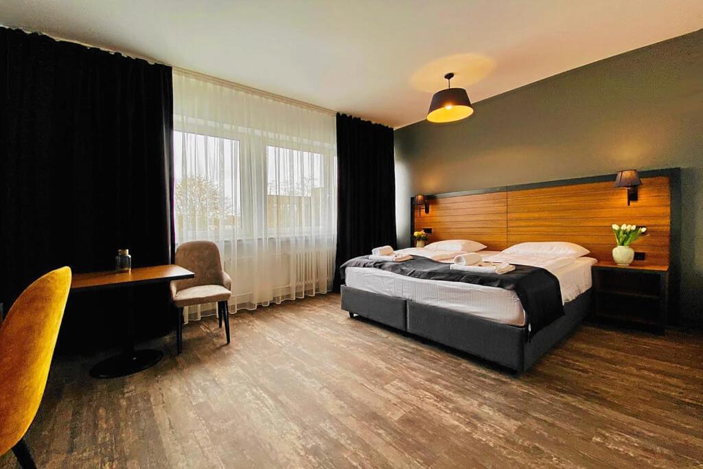 a hotel room with a bed and a desk and a table at MB Hotel in Bremen