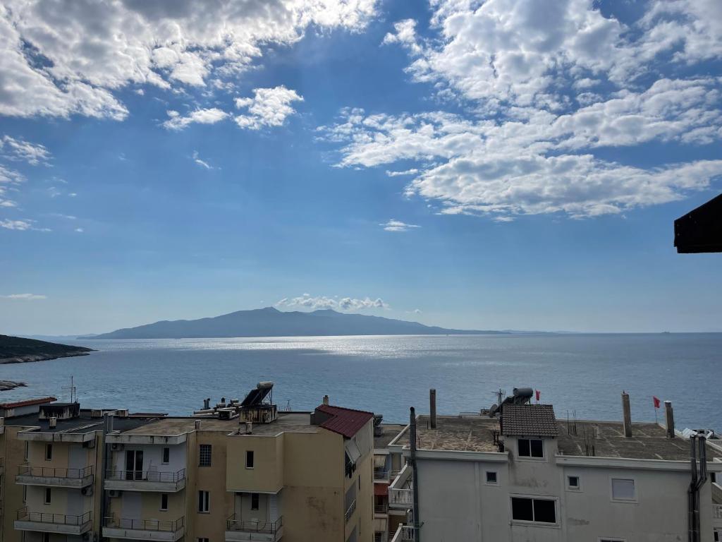 a view of the ocean from a city with buildings at Sea Gate Apartments in Sarandë