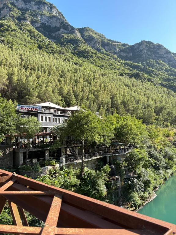 a view of the hotel from the river at Bar-Restaurant-Hotel River in Këlcyrë Fshat