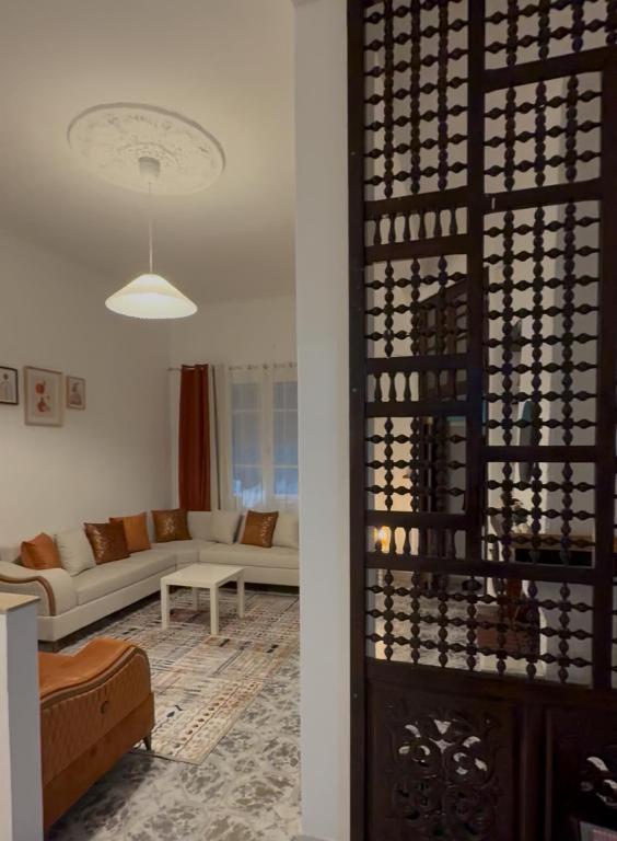a living room with a couch and a wine rack at Maison Mira in Bizerte