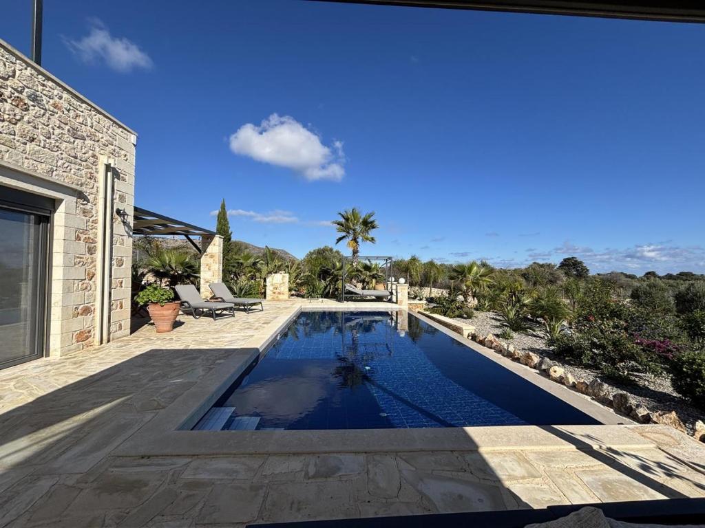 a swimming pool in the backyard of a house at MayaElisa Villa with Heated Pool, By Hellocrete in Vamos