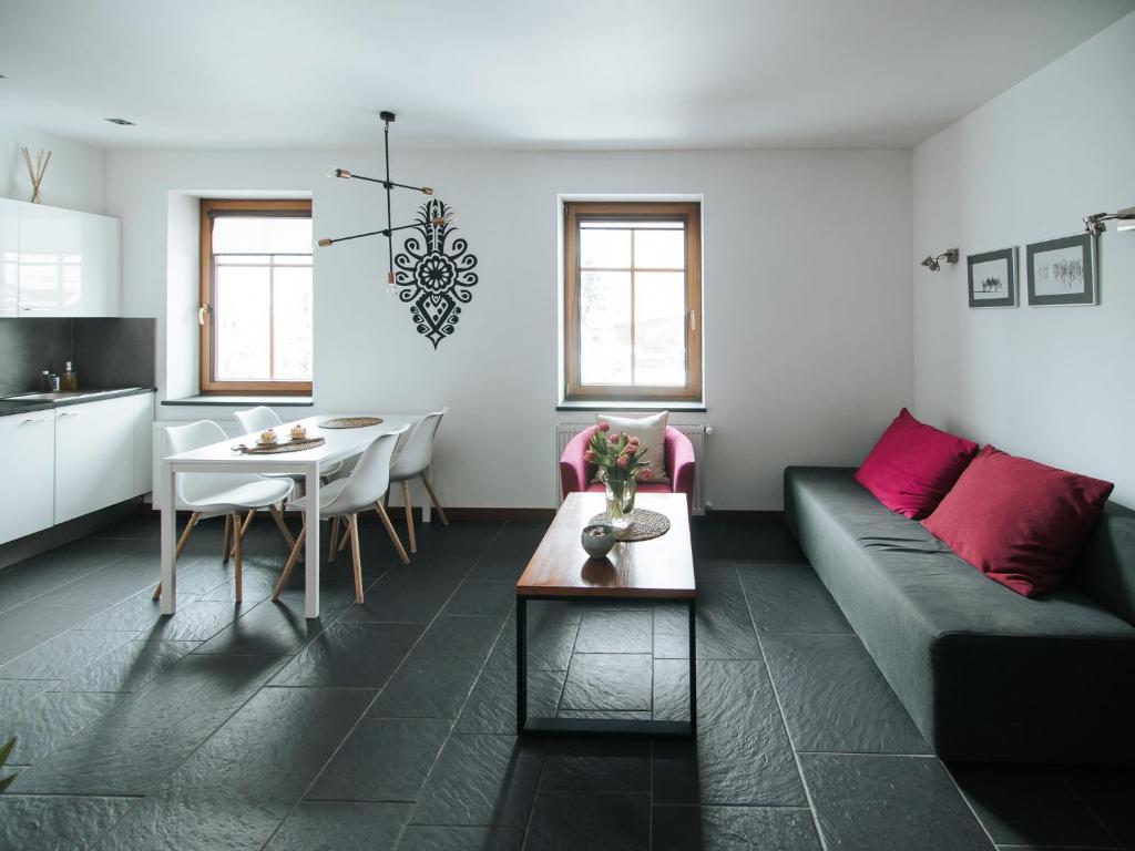 a living room with a couch and a table at Pensjonat Maria 2 in Szczyrk