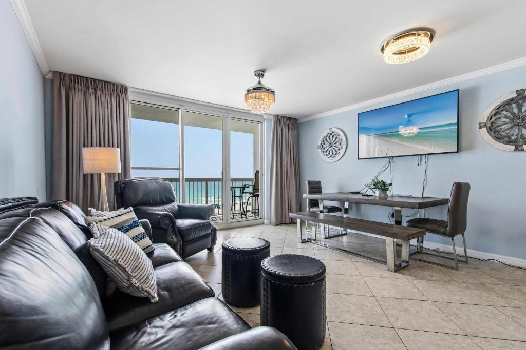 a living room with a couch and chairs and a desk at Pelican Beach Resort 504 in Destin
