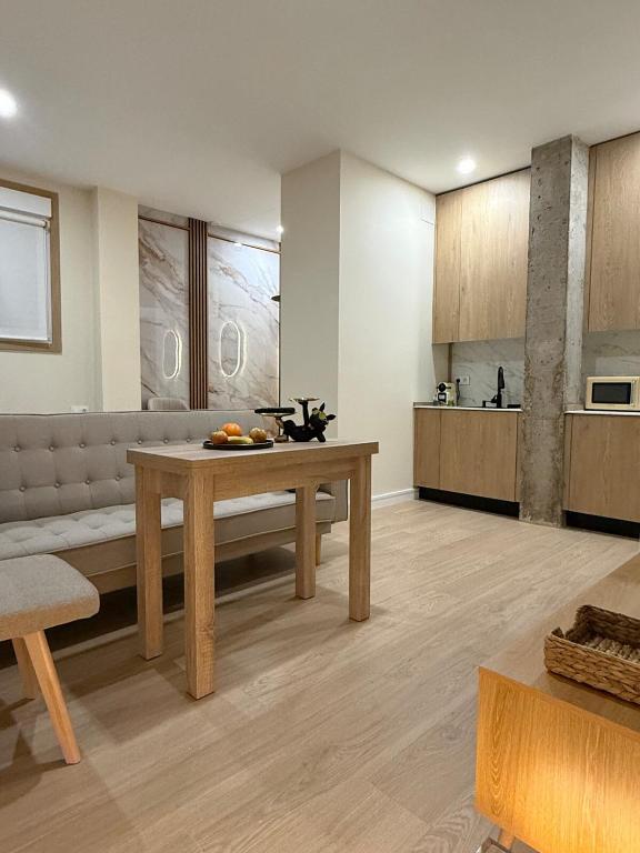 a large living room with a table and a kitchen at Bianca Suites III in Bormujos