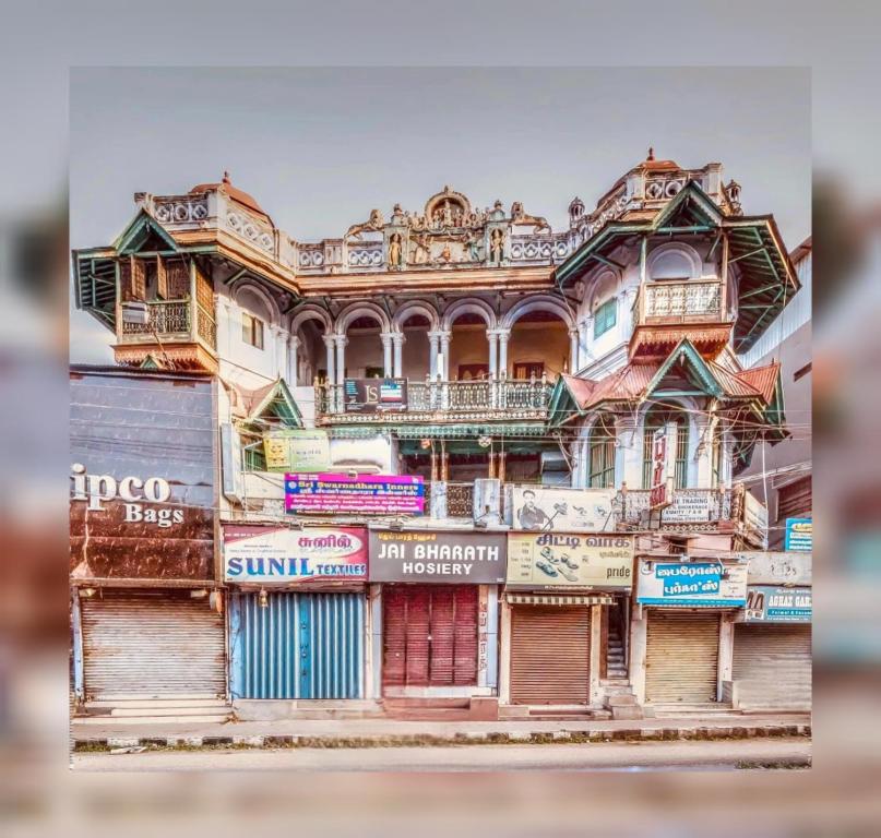 an old house with colorful doors and windows at Umbrella Guest House - Meenakshi Suite in Madurai
