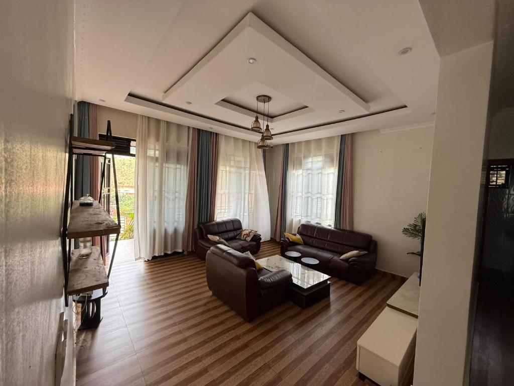 a living room with two couches and a table at Eden house in Kigali