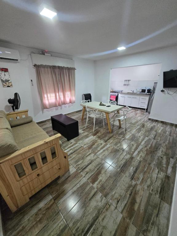 a room with a bed and a table and a desk at Veronica mini home 1 in Verónica