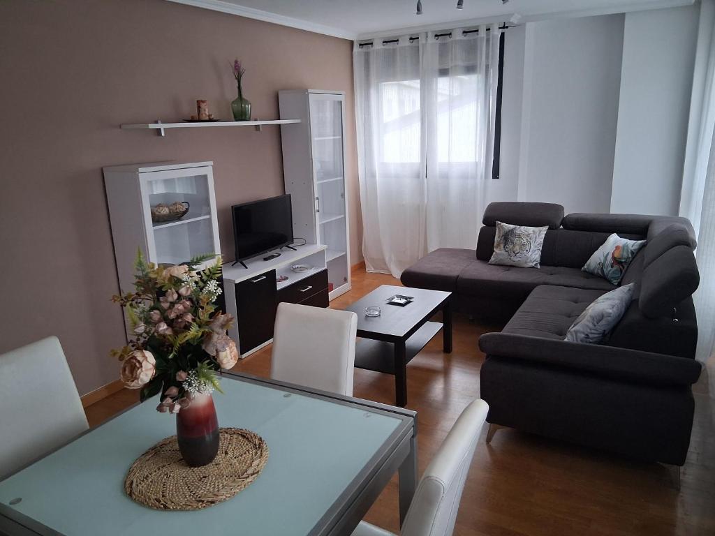 a living room with a couch and a table at Ayalga2 in Villaviciosa