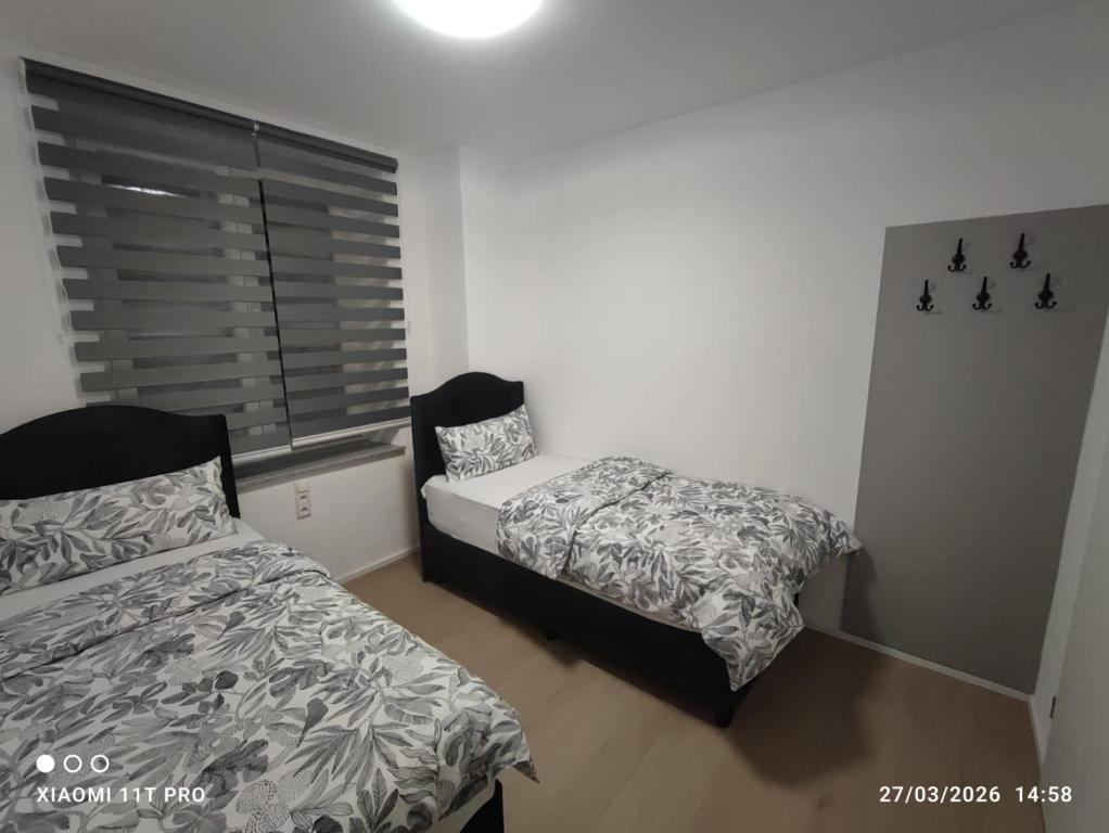 a bedroom with a bed and a chair in it at City Apartments Göppingen in Göppingen