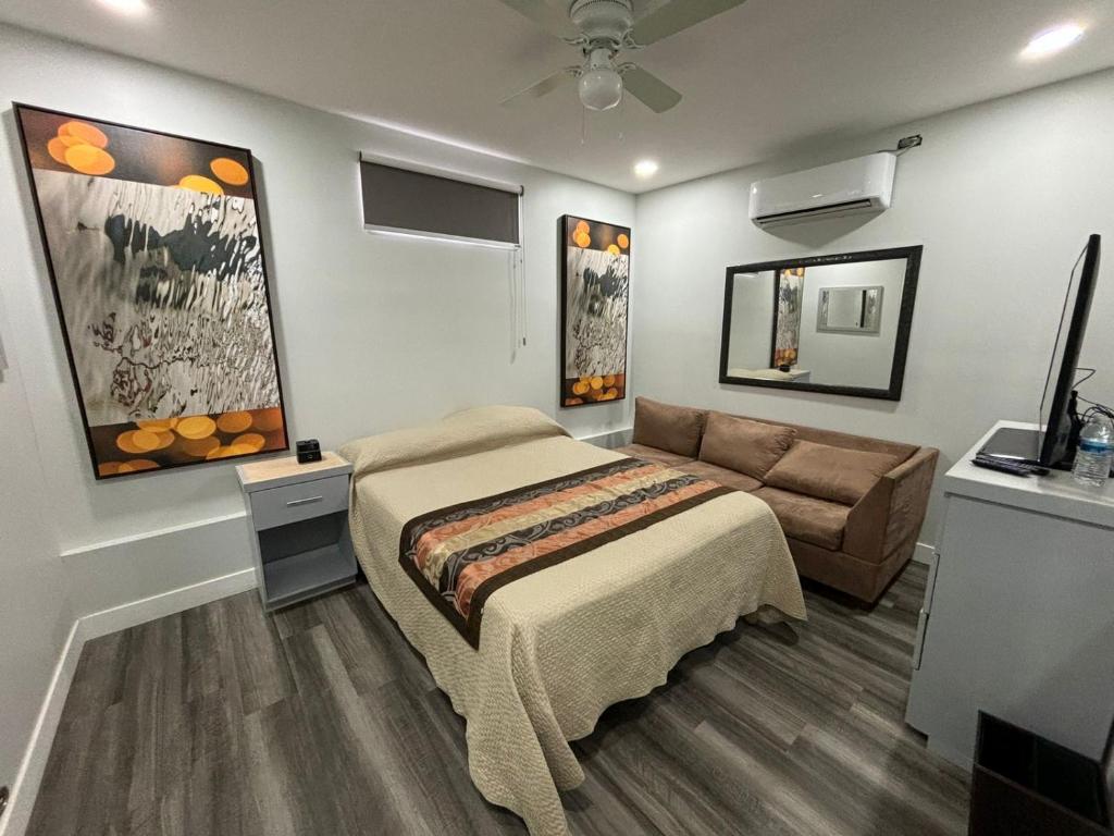 a bedroom with a bed and a couch at Mini suite in House or Varz hotel boutique in Tijuana