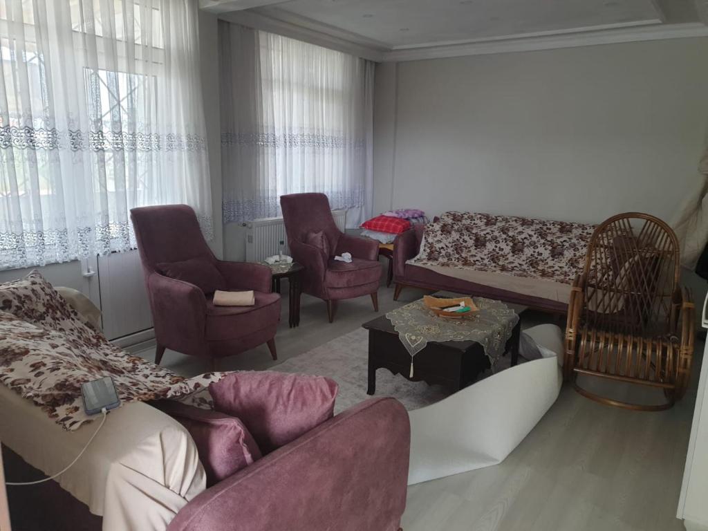 a living room with a couch and chairs and a table at Yazlık in Yukarı Kocaali