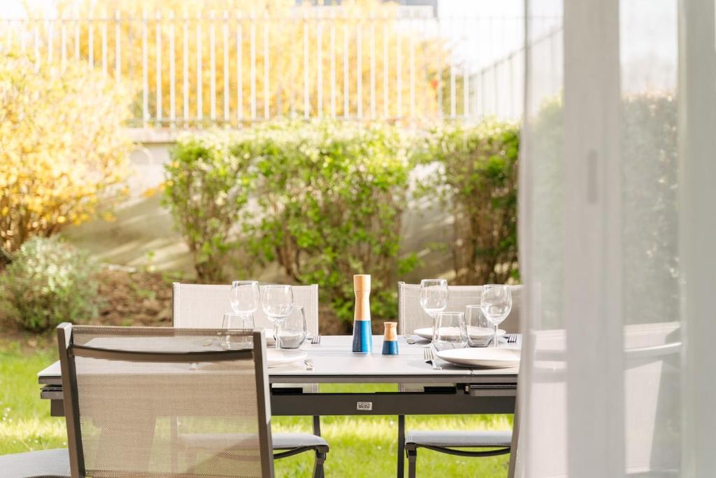 a table with wine glasses sitting on a balcony at Le repere du golfe in Vannes