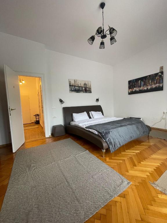 a bedroom with a bed and a rug at Rozelor Double Room in Timişoara