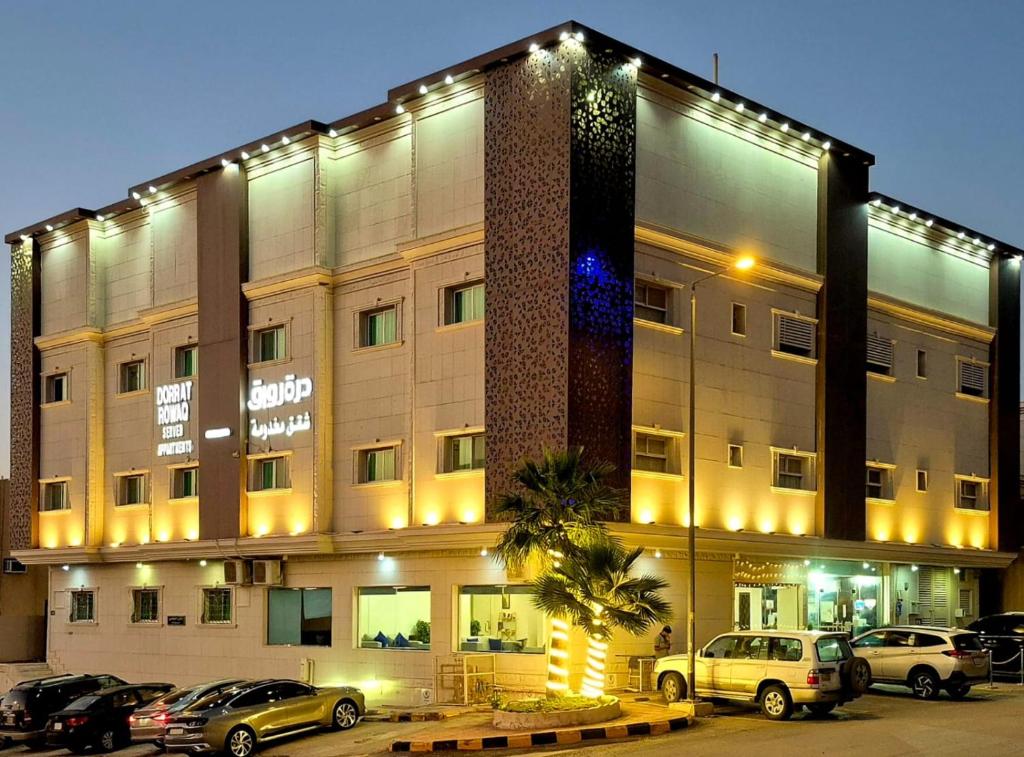 a large building with cars parked in front of it at درة رواق للشقق المخدومة - Durrat Rwaq Serviced Apartments in Riyadh
