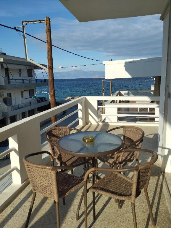 a table and chairs on the balcony of a boat at Blue Infinity in Káto Ássos