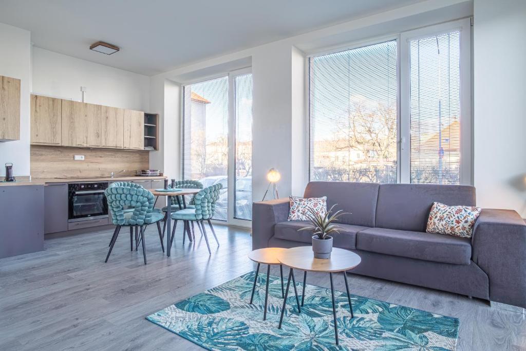 a living room with a couch and a table at Apartmán Nová Dragounská in Klatovy