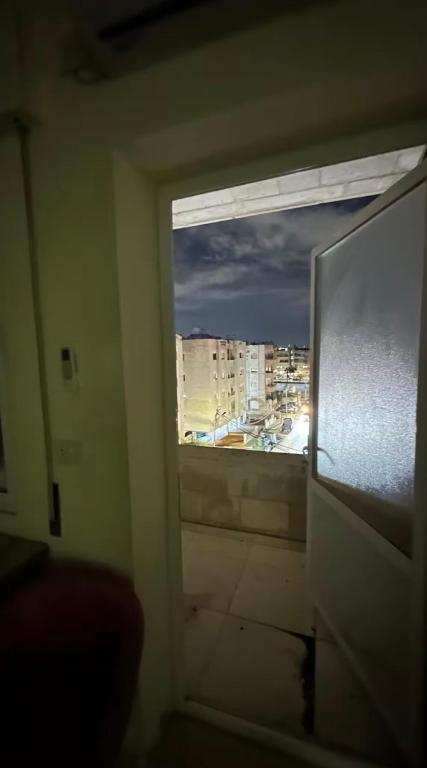 a window in a room with a view of a city at Local apartment in Irbid