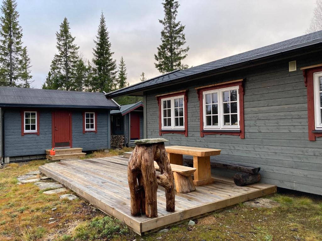 a picnic table on a wooden deck in front of a house at Cabin in Tydal, enjoy! in Tydal