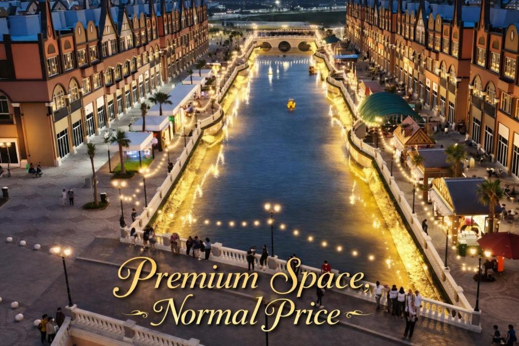 a city square with a fountain in a town at night at Stylish 2BR Near Food - Shops-Fast WiFi-Late Checkin in Gedong